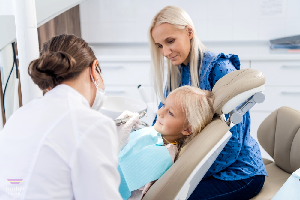 a mother watching an orthodontist taking care of her little daughters teeth as one of the procedures to how to fix overbite in little rock, AR