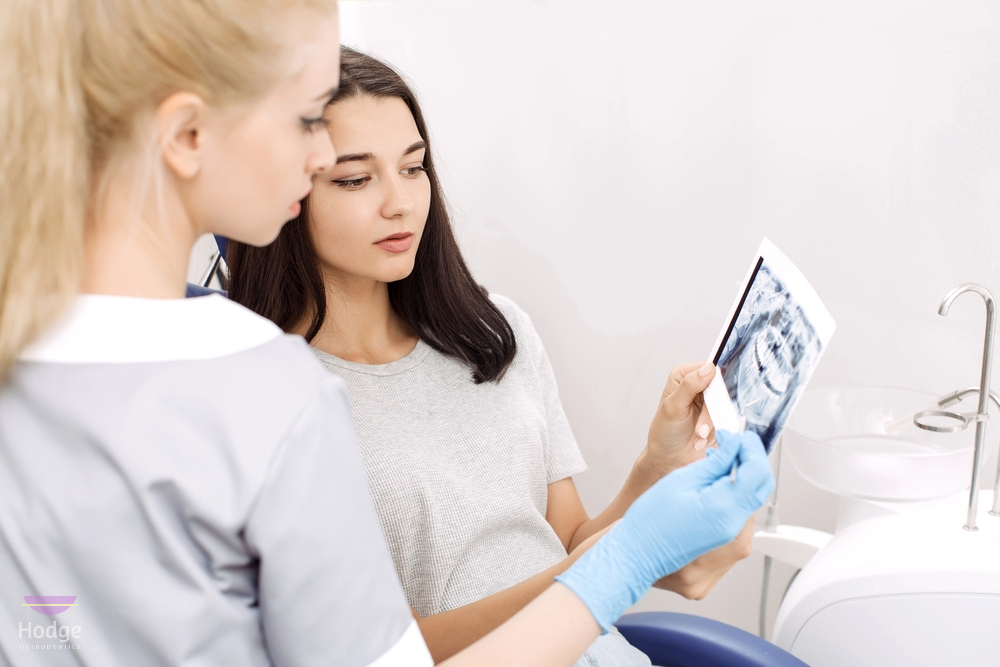orthodontist showing x ray image to patient as one of the procedures to how to fix overbite in little rock, AR