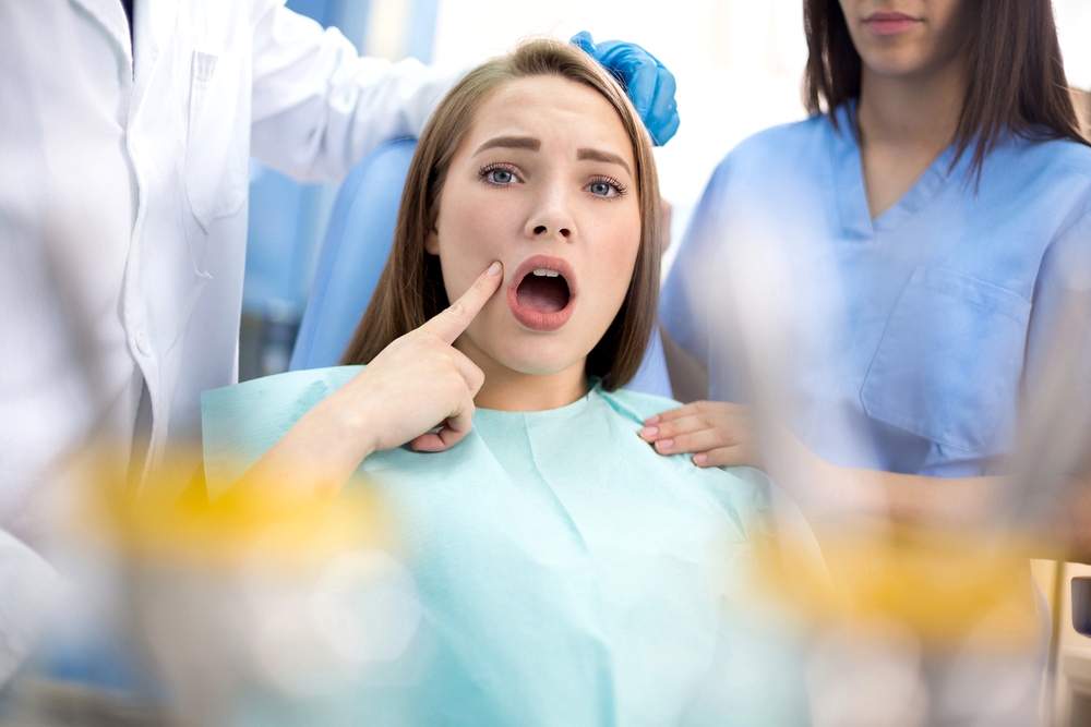 girl in dental ambulance show sore spot - overbite vs underbite in Little Rock, AR.